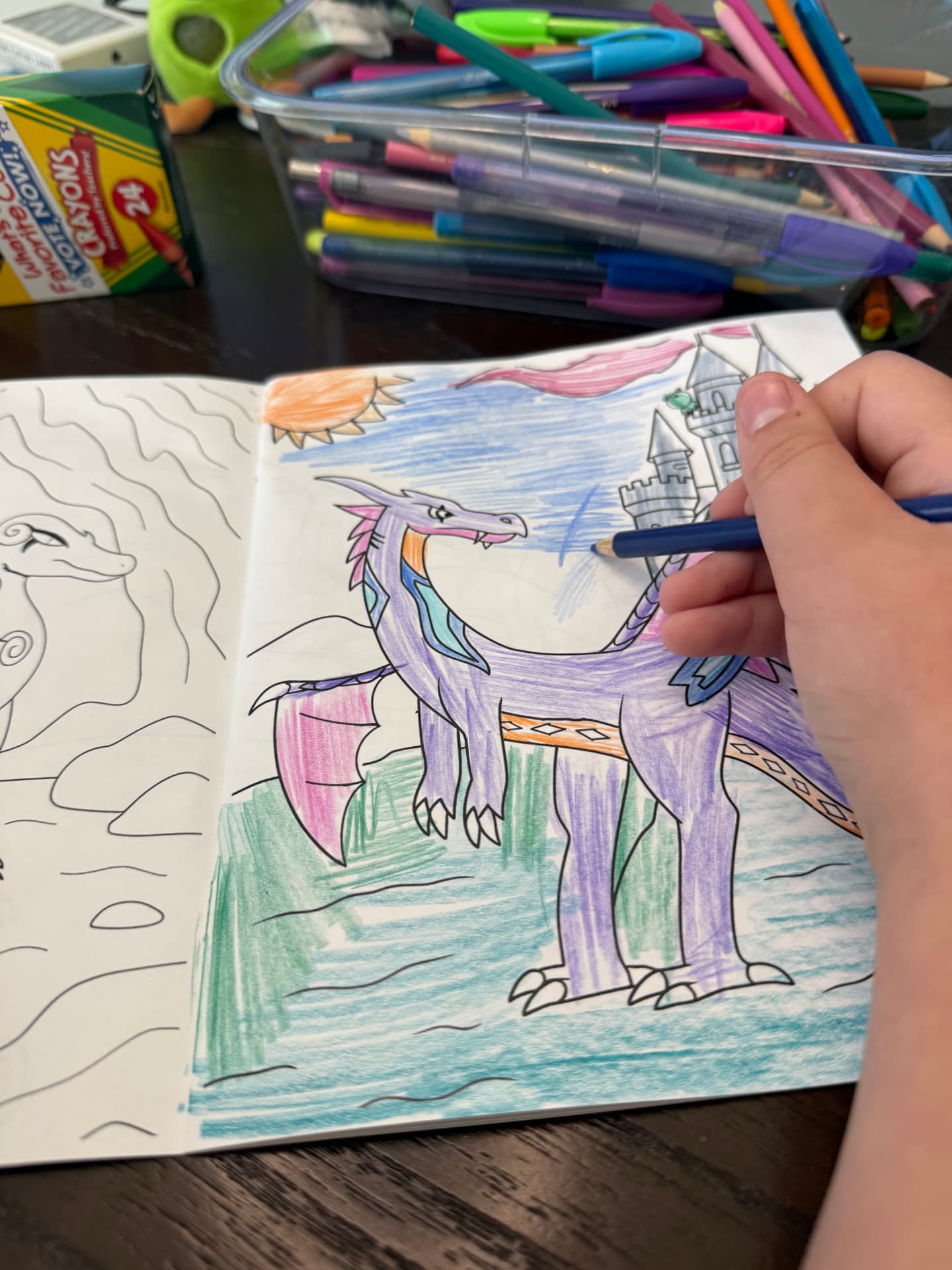 A reader coloring a purple dragon near a castle